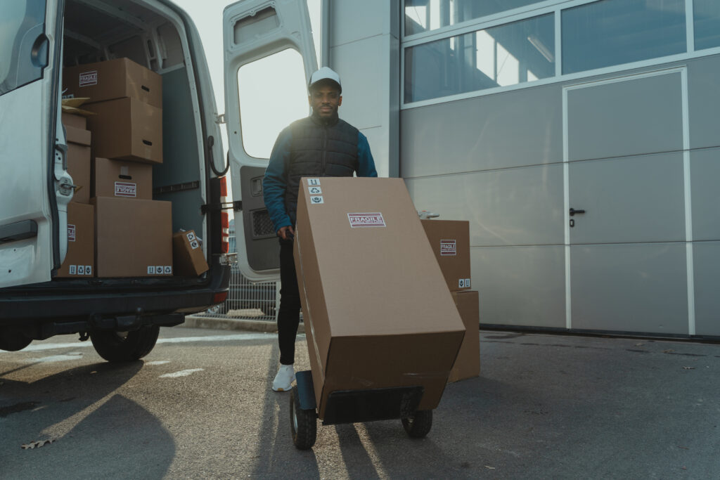 A man moving boxes using a dolly
