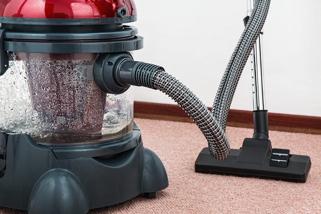 cleaning a carpet with a vacuum cleaner