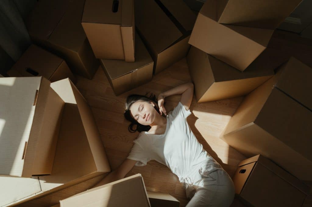 Woman sitting in boxes packing for out of state move