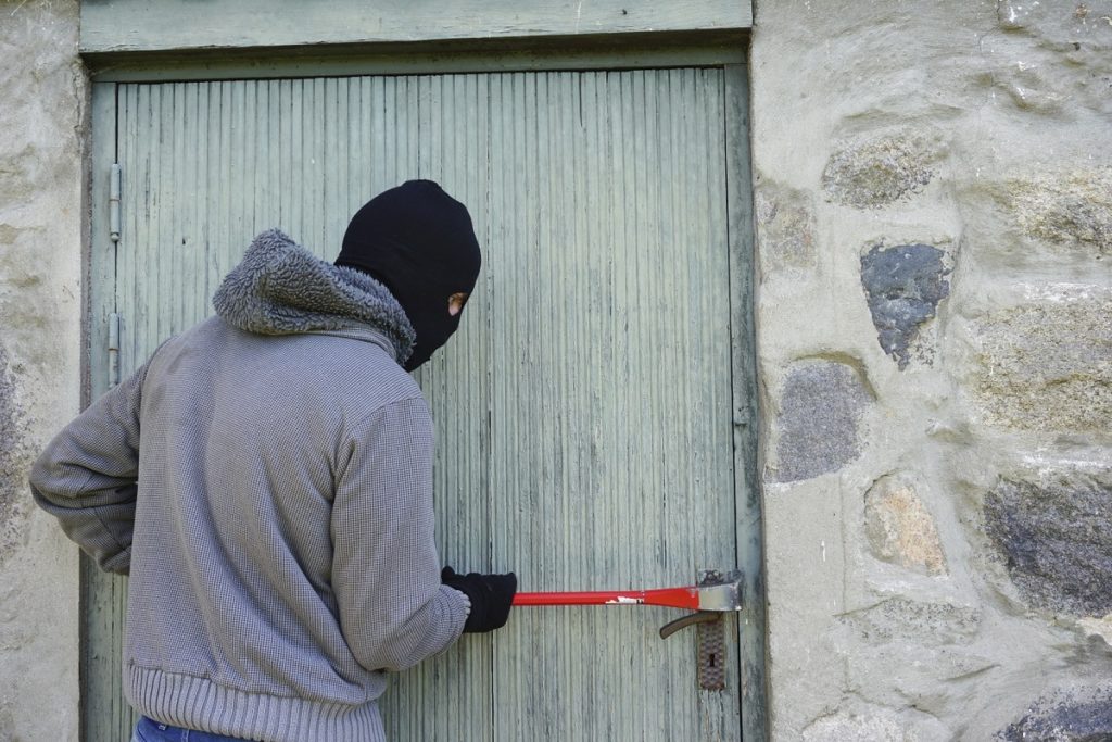 Burglar breaking door lock