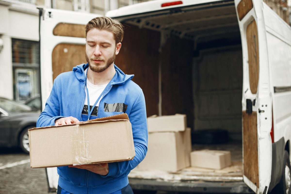A man packing boxes in a moving truck