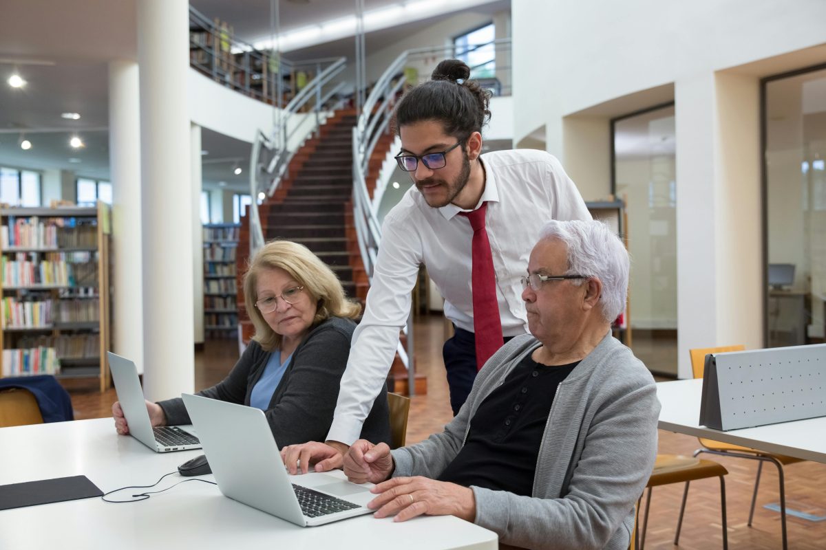 Adults on laptops studying