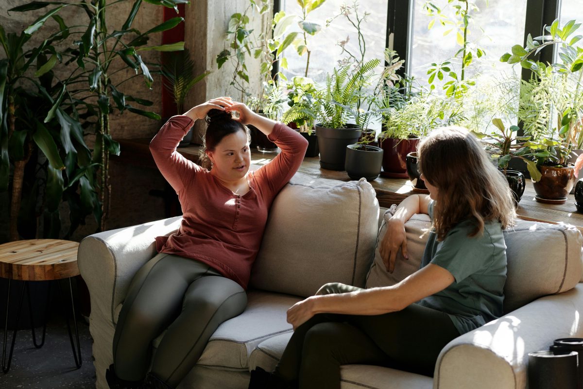 Women with disabilities sitting on a couch chatting