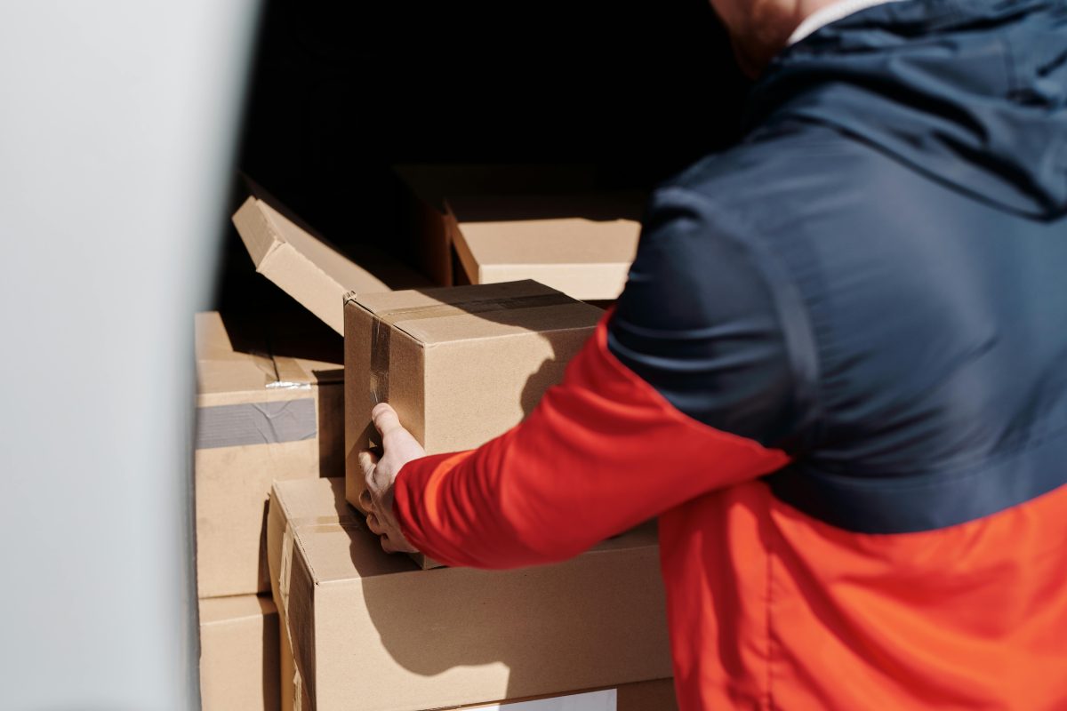 Person loading boxes into a moving truck