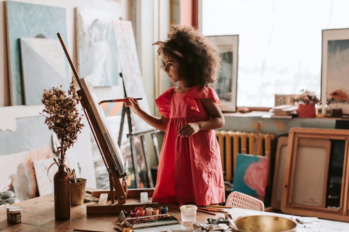 A little girl painting in an art studio