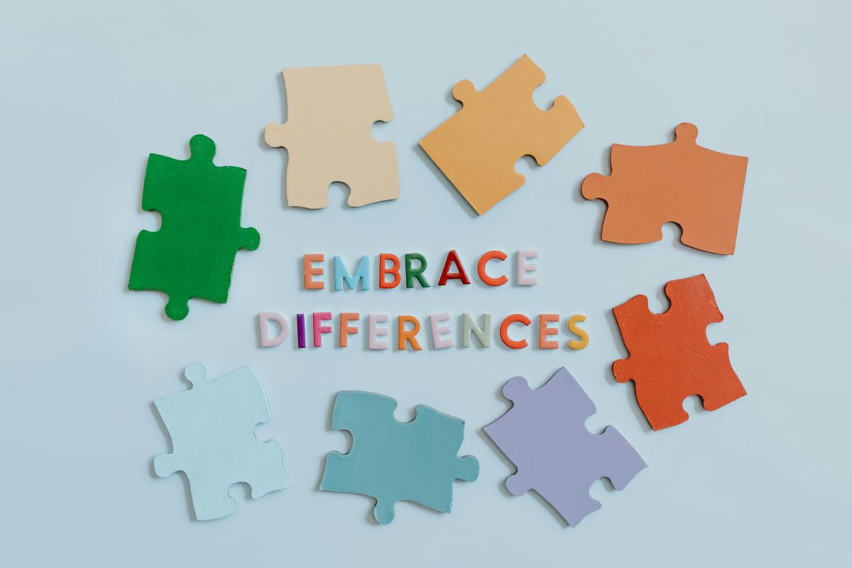 Colorful puzzle pieces and a text saying "embrace differences"