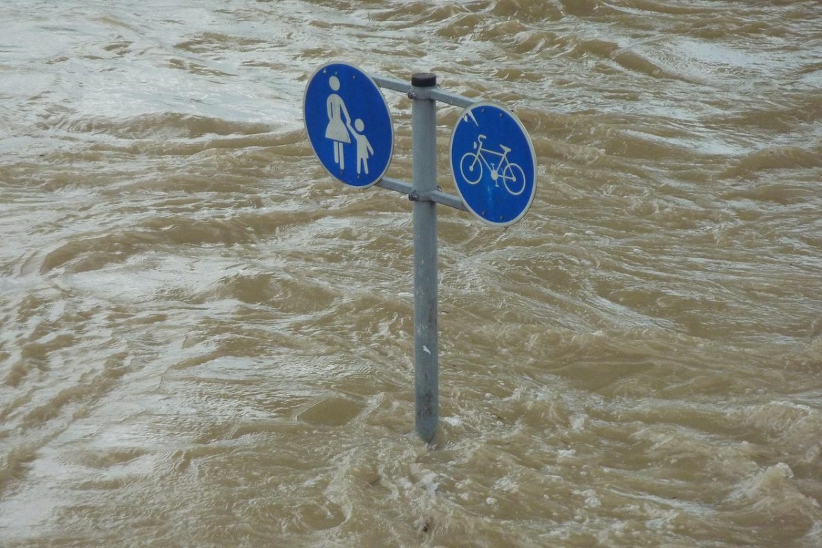 A sign surrounded by floodwaters