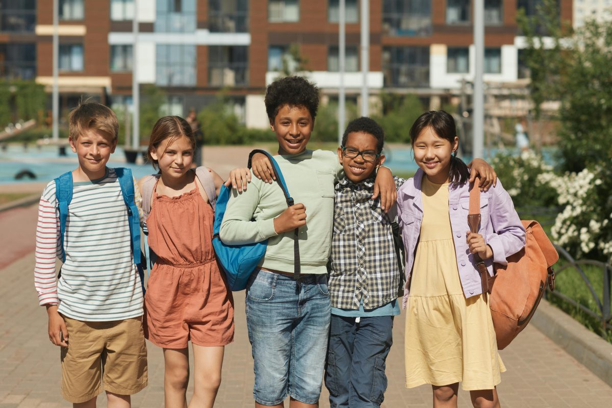 Group of students standing next to each other while smiling at the camera