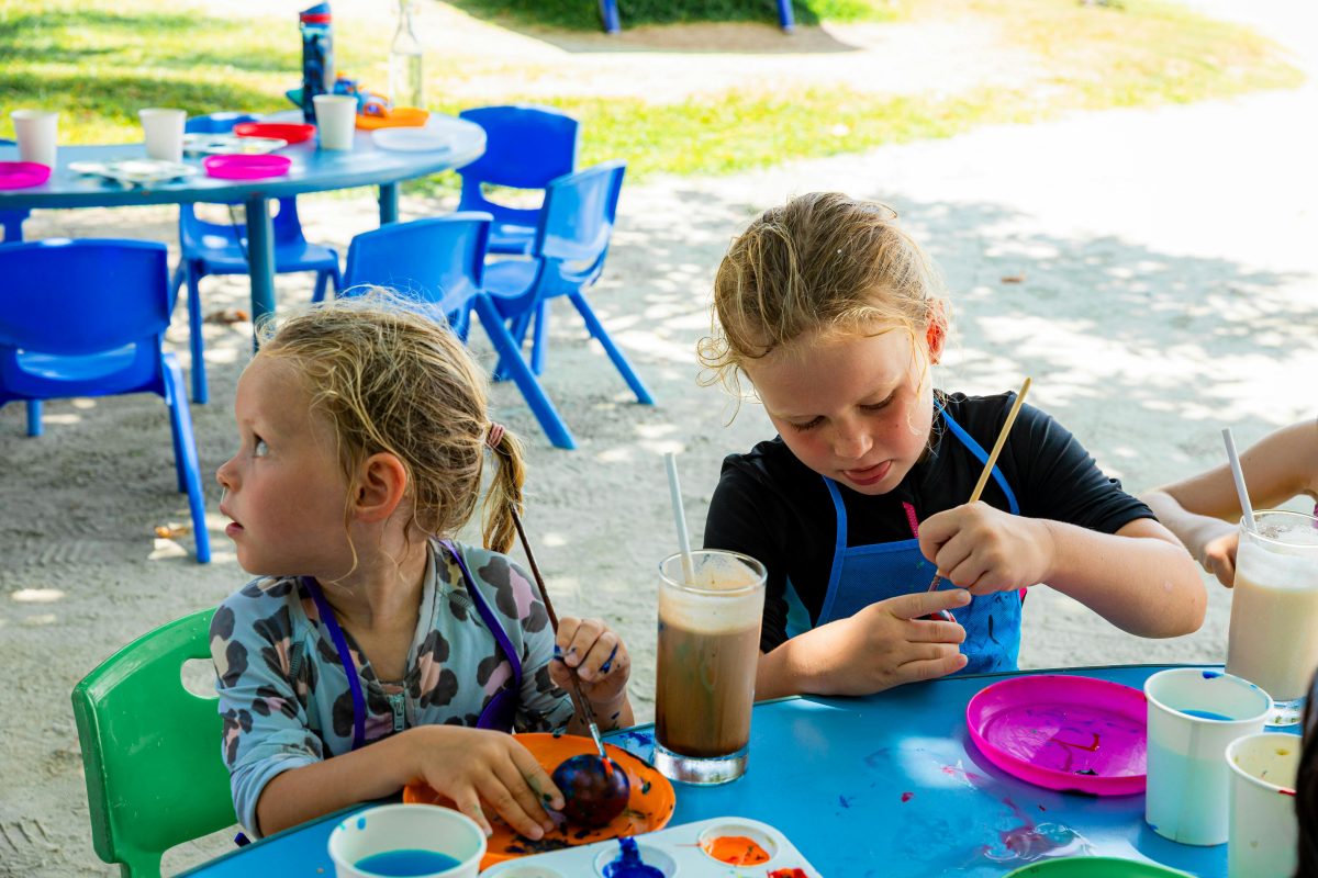 Two children painting outside