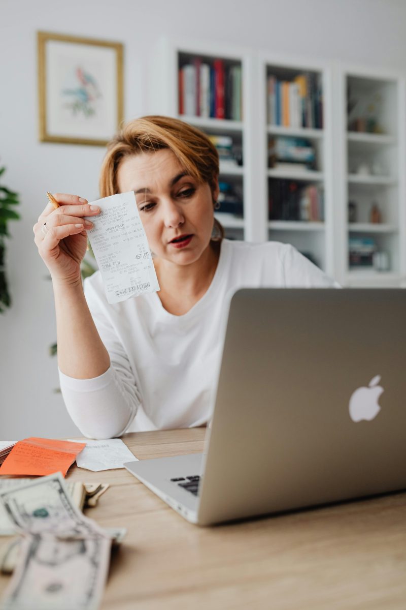 A stressed woman in front of a laptop