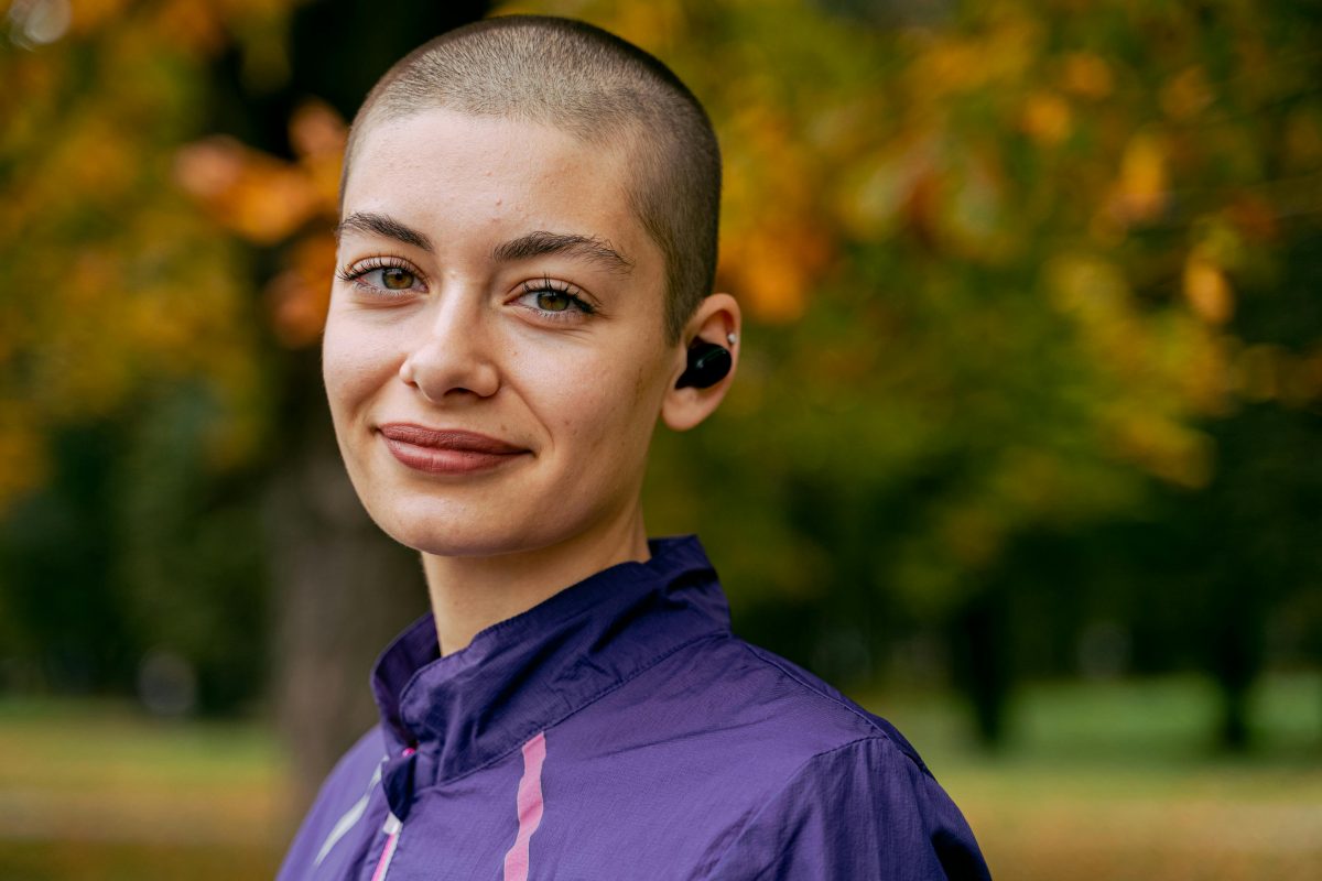 Smiling woman in purple hoodie