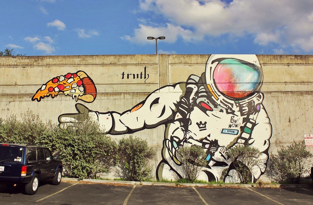 Street art of an astronaut with pizza in Austin, TX