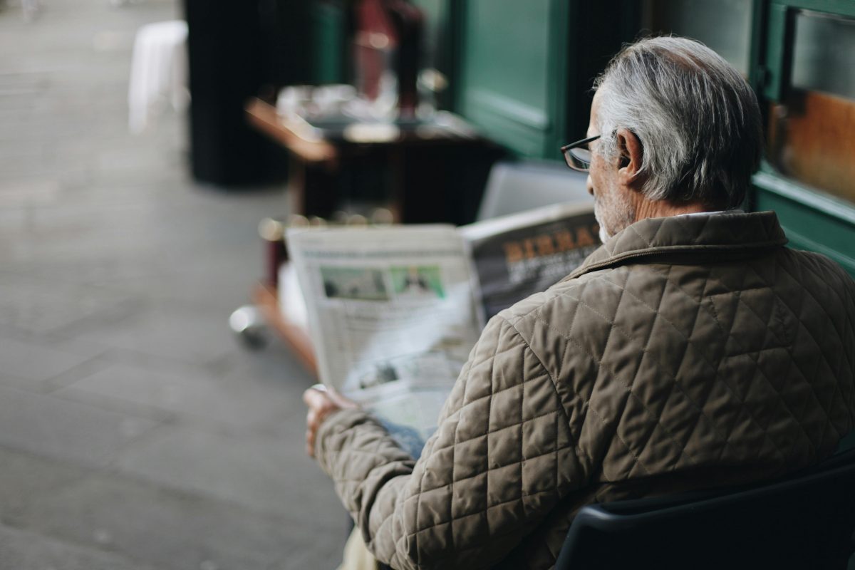 Man sitting reading newspaper