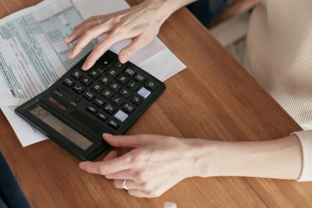 A person calculating their bills