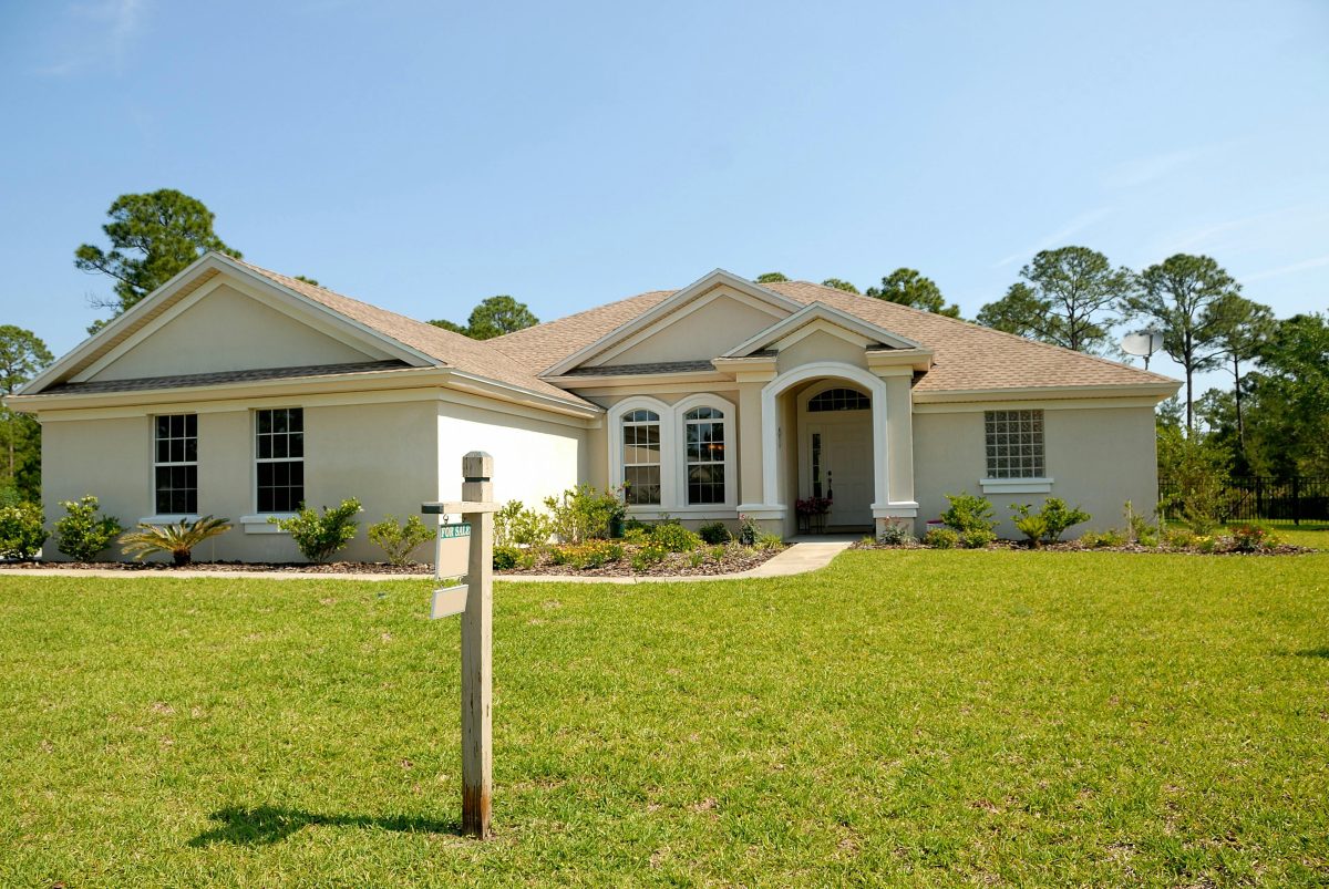 A white house with a pristine yard