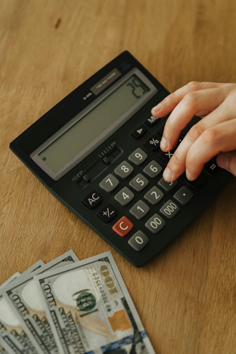 A person using a calculator to budget moving costs
