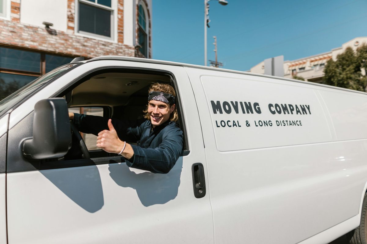 Man driving truck with "Moving Company" written on the side