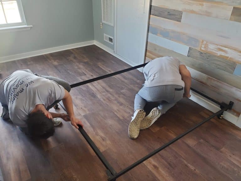 Furniture Installers putting together bed for commerical job